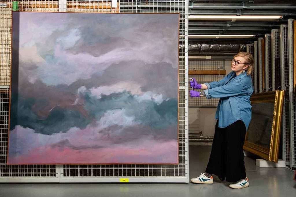 Exhibition curator Kirsty Matheson with Jon Schueler’s 'Storm at Sea Remembered'. Image Alan Richardson