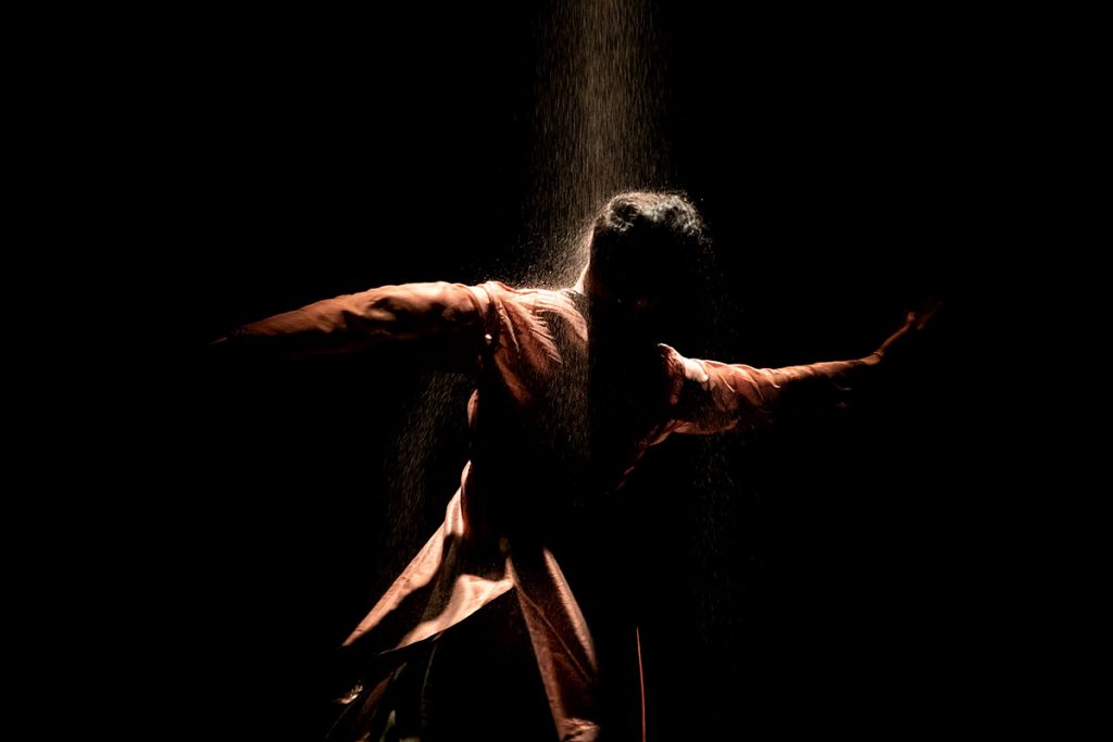Dancer in sand shower. Image Jassy Earl, EIF