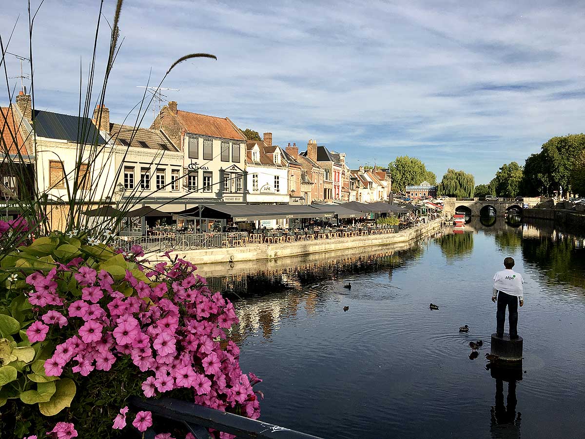 The river Somme, Amiens, with Stephan Balkenhol's 'L’homme et sa Bouée' at right
